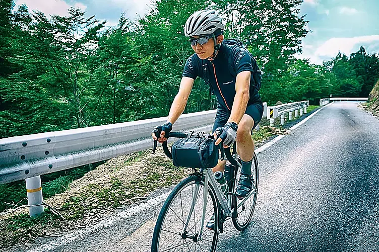 山道の道路をサイクリングしている様子